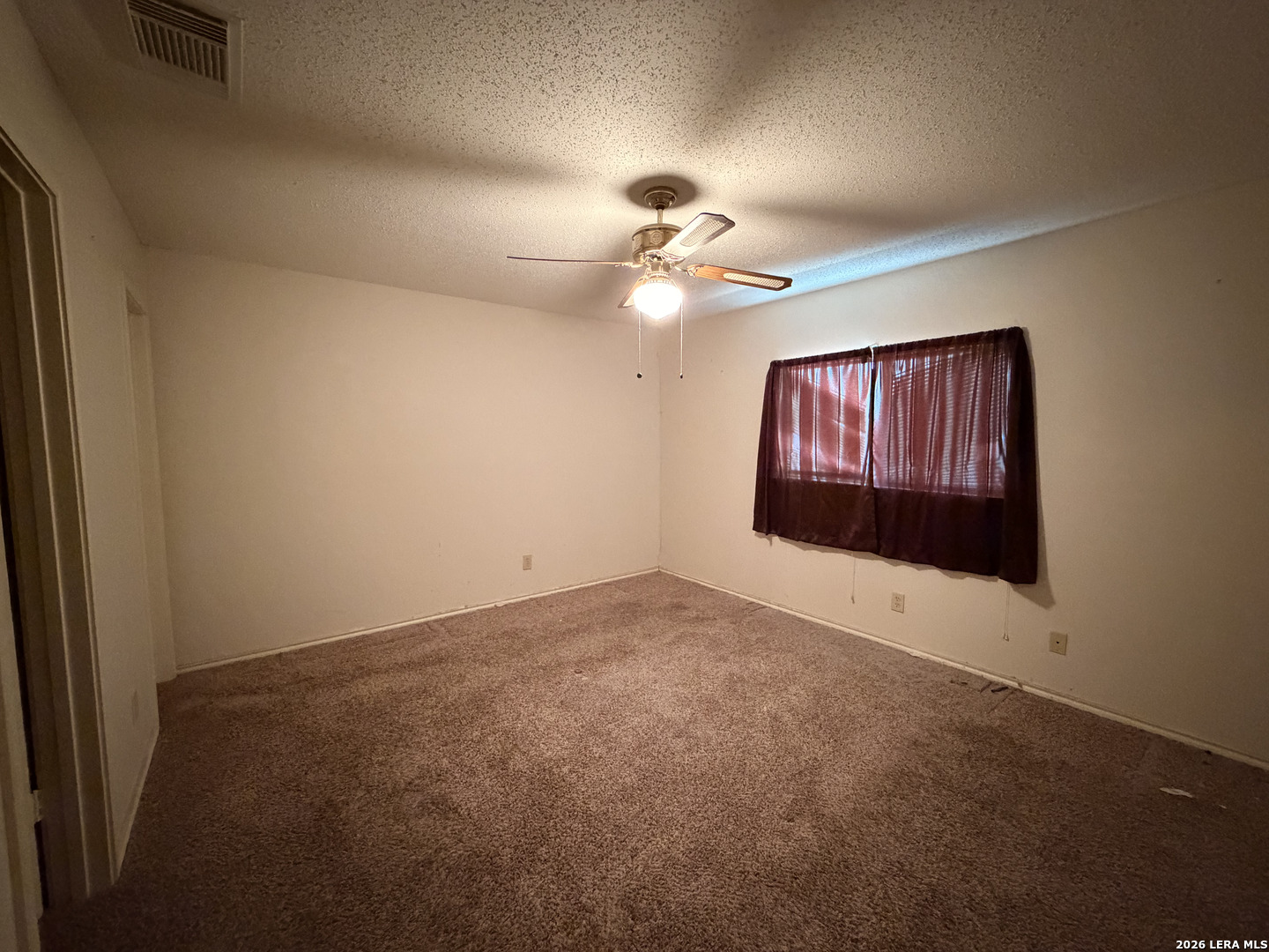 8349 Morning Grove Converse, TX 78109 - Photo 16 of 27 an empty room with a ceiling fan and a window