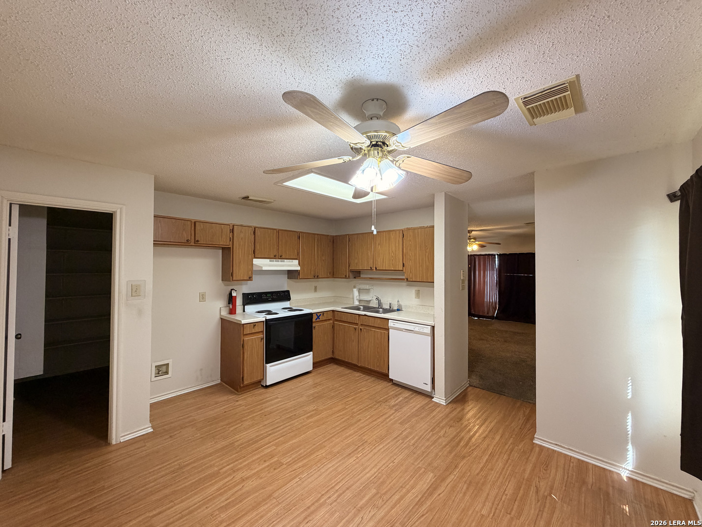 8349 Morning Grove Converse, TX 78109 - Photo 6 of 27 a kitchen with a refrigerator and a stove top oven