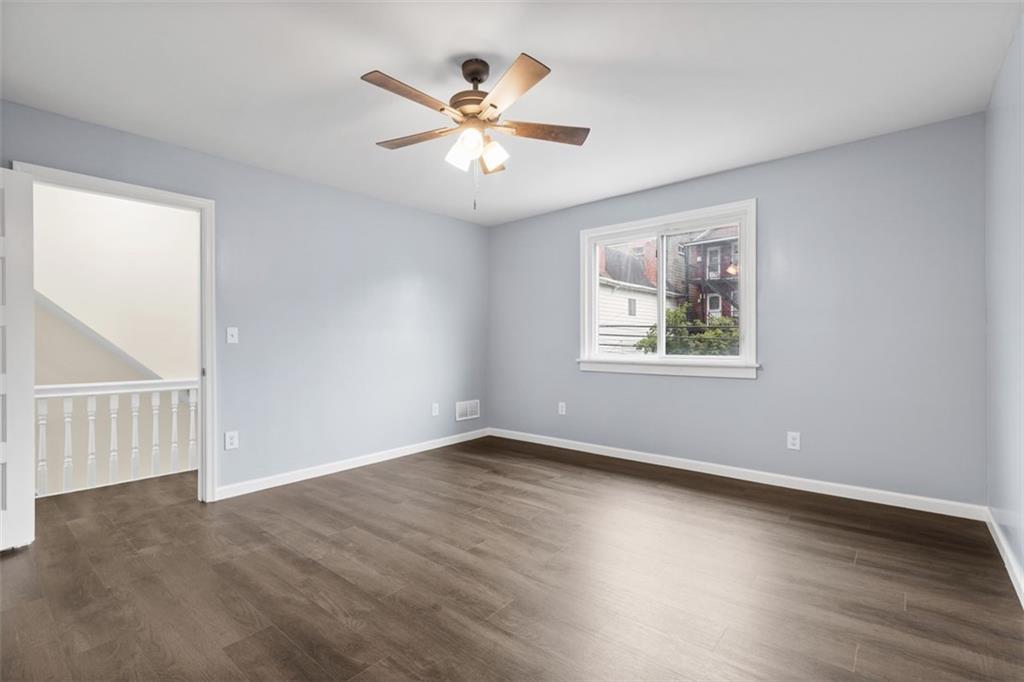519 Center Street Carnegie, PA 15106 - Photo 17 of 44 a view of an empty room with wooden floor and a window