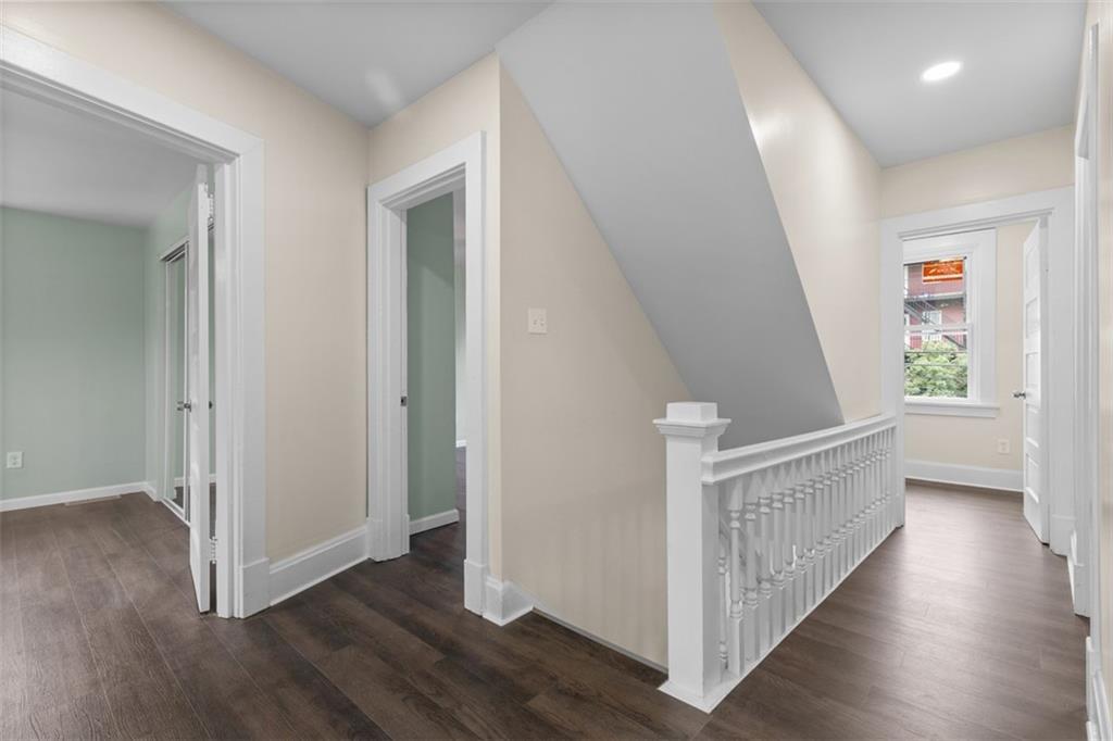 519 Center Street Carnegie, PA 15106 - Photo 22 of 44 a view of a hallway with wooden floor and stairs