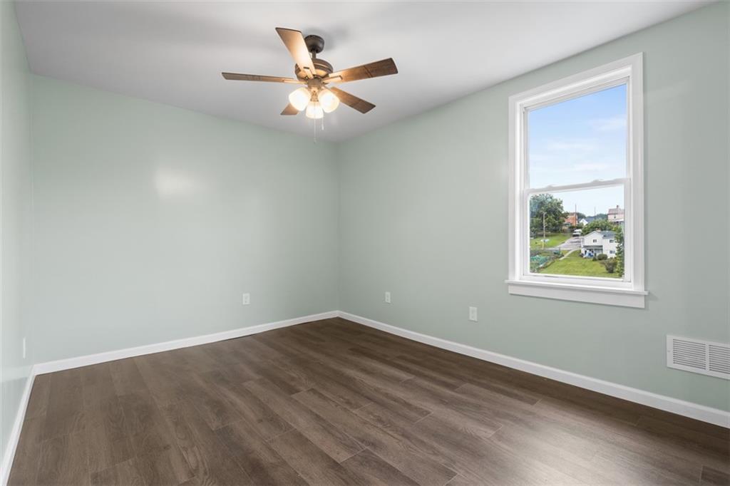 519 Center Street Carnegie, PA 15106 - Photo 23 of 44 a view of an empty room with wooden floor and a window
