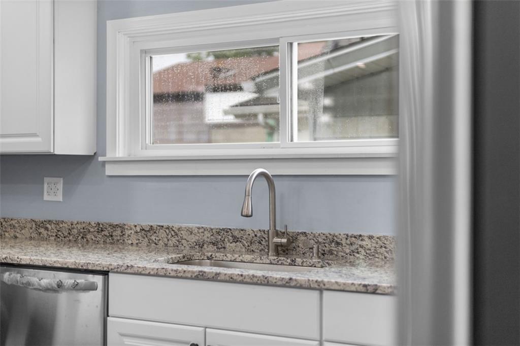 519 Center Street Carnegie, PA 15106 - Photo 10 of 44 a kitchen with granite countertop a window sink and cabinets