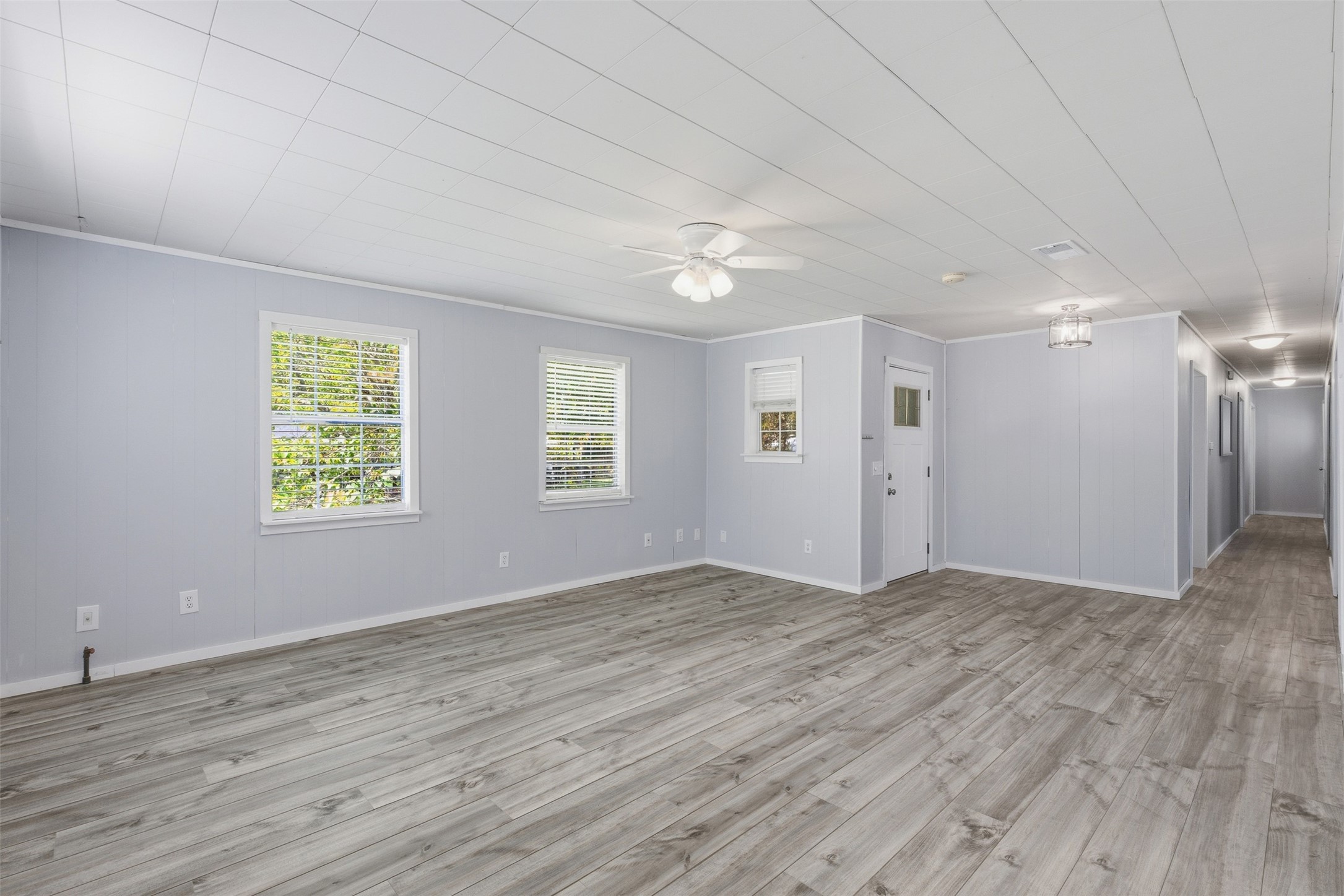 1310 Brazos Street Hempstead, TX 77445 - Photo 5 of 32 a view of an empty room with window and wooden floor