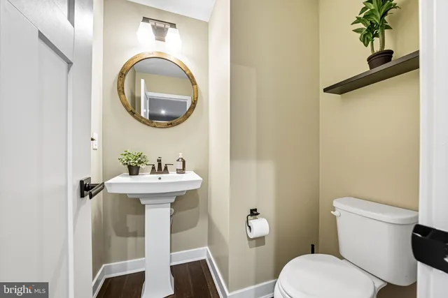 a bathroom with a toilet sink and mirror