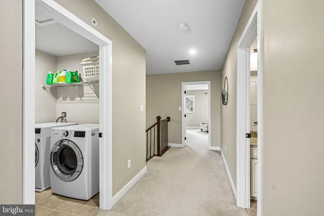 a view of a hallway with washer and dryer