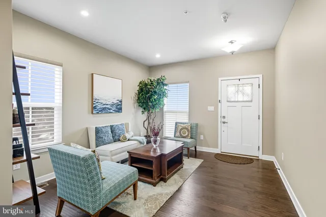 a living room with furniture and a potted plant