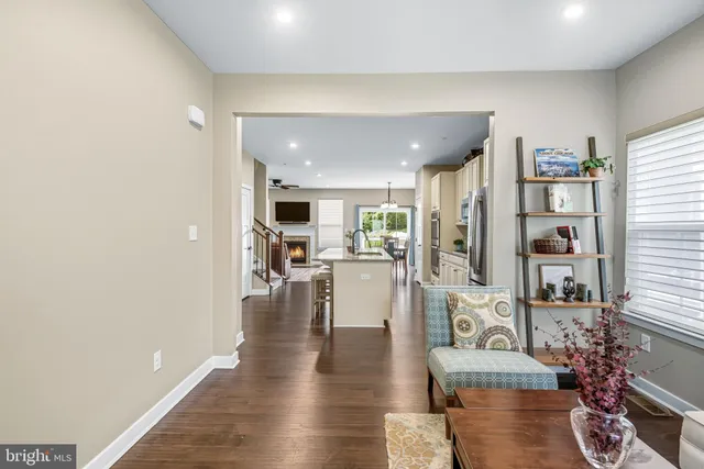 a kitchen with kitchen island white cabinets and stainless steel appliances