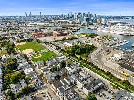 an aerial view of residential houses with outdoor space