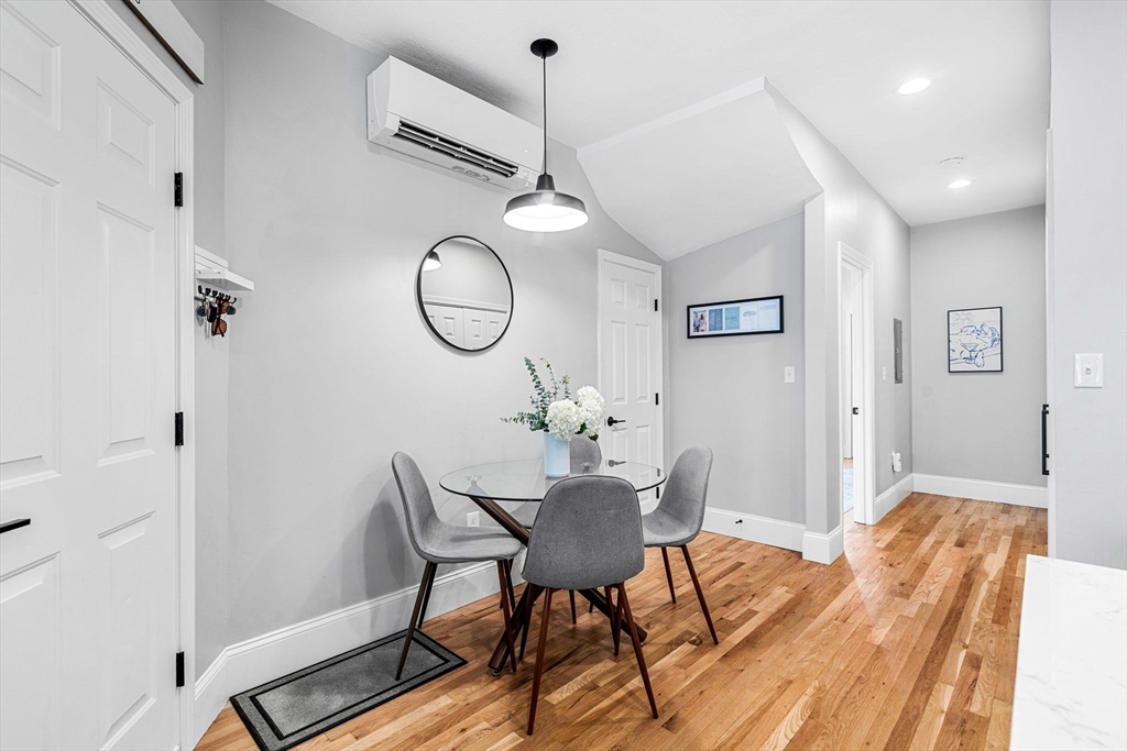7 O Street, Unit 1 Boston, MA 02127 - Photo 6 of 15 a view of a dining room with furniture window and wooden floor