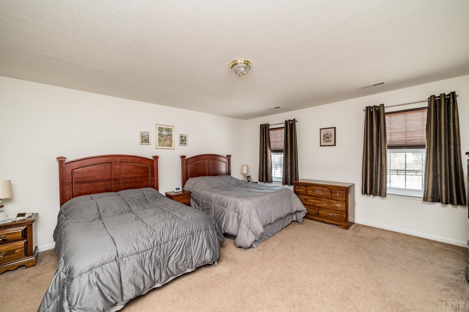 312 Longhill Road Goode, VA 24556 - Photo 47 of 56 a bedroom with two beds and a large window