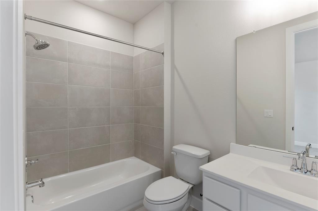 1545 Rodeo Ridge Drive Georgetown, TX 78628 - Photo 13 of 33 Full bath featuring vanity and washtub / shower combination