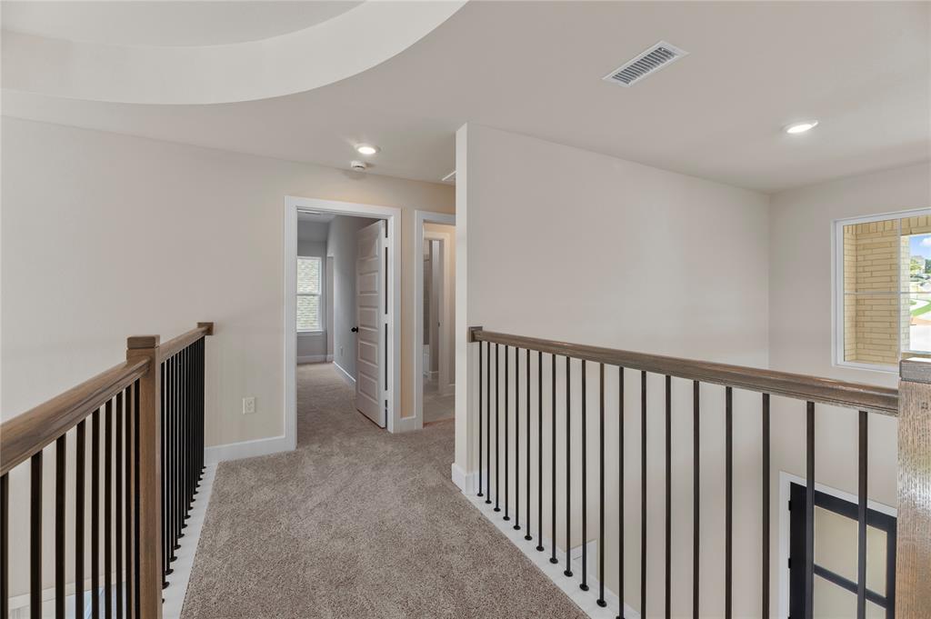 1545 Rodeo Ridge Drive Georgetown, TX 78628 - Photo 14 of 33 Hallway featuring light carpet, recessed lighting, and an upstairs landing