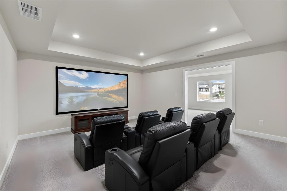 1545 Rodeo Ridge Drive Georgetown, TX 78628 - Photo 17 of 33 Cinema with a tray ceiling, recessed lighting, and light colored carpet