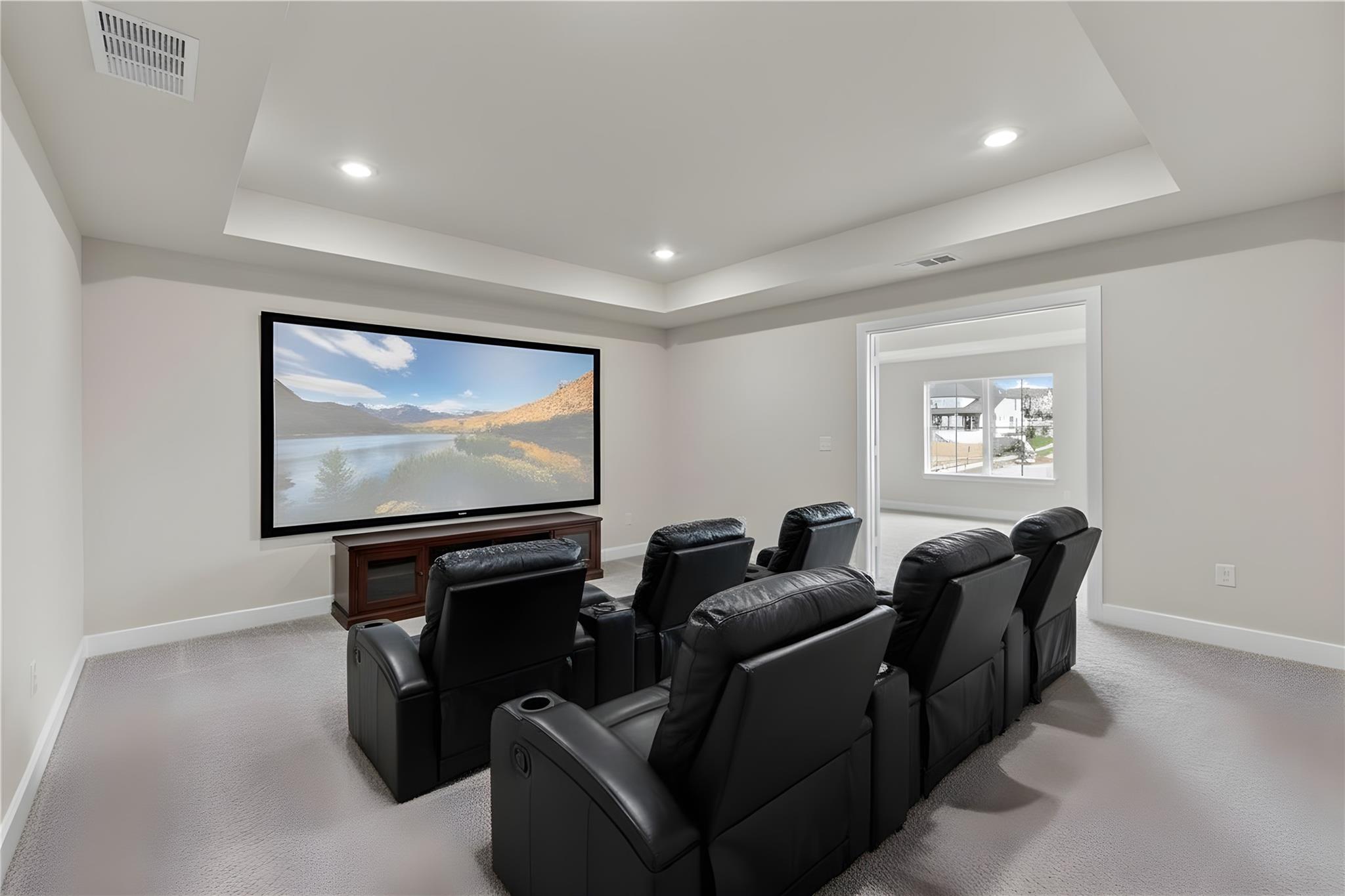 1545 Rodeo Ridge Drive Georgetown, TX 78628 - Photo 17 of 33 Cinema with a tray ceiling, recessed lighting, and light colored carpet
