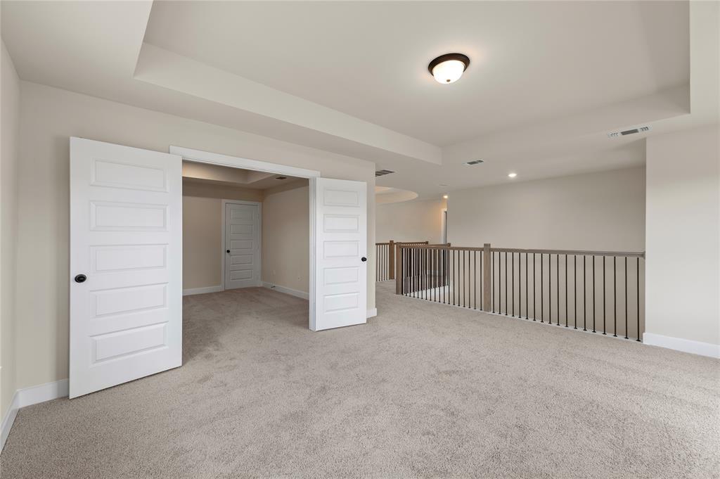 1545 Rodeo Ridge Drive Georgetown, TX 78628 - Photo 18 of 33 Spare room featuring a raised ceiling, light colored carpet, and recessed lighting