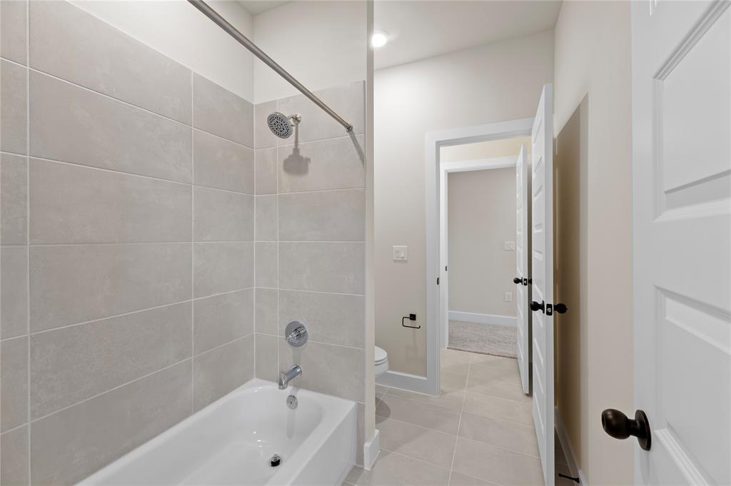 1545 Rodeo Ridge Drive Georgetown, TX 78628 - Photo 20 of 33 Bathroom with washtub / shower combination and light tile patterned floors