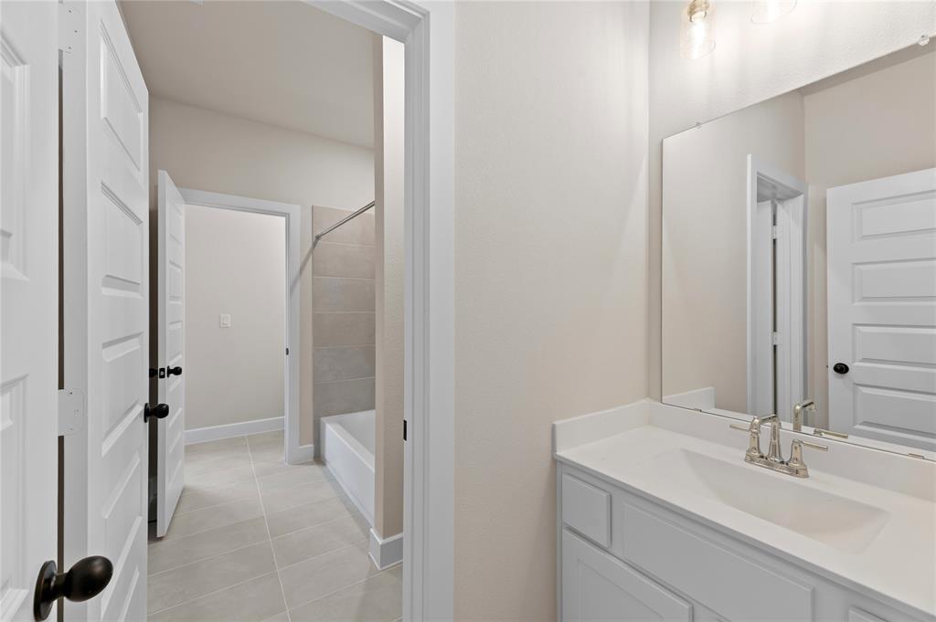 1545 Rodeo Ridge Drive Georgetown, TX 78628 - Photo 22 of 33 Full bathroom with vanity, shower / washtub combination, and light tile patterned floors