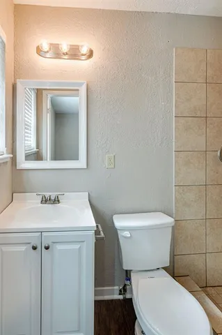 a white toilet sitting next to a bathroom sink