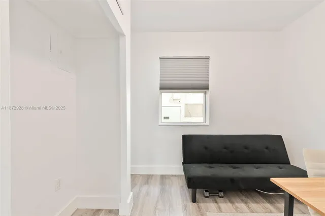 a living room with a couch and a window
