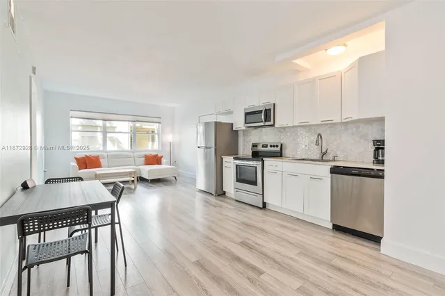 a kitchen with white cabinets and white appliances