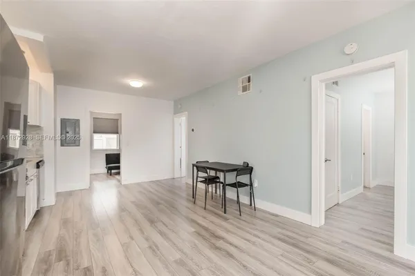 a view of a livingroom with wooden floor and a fireplace