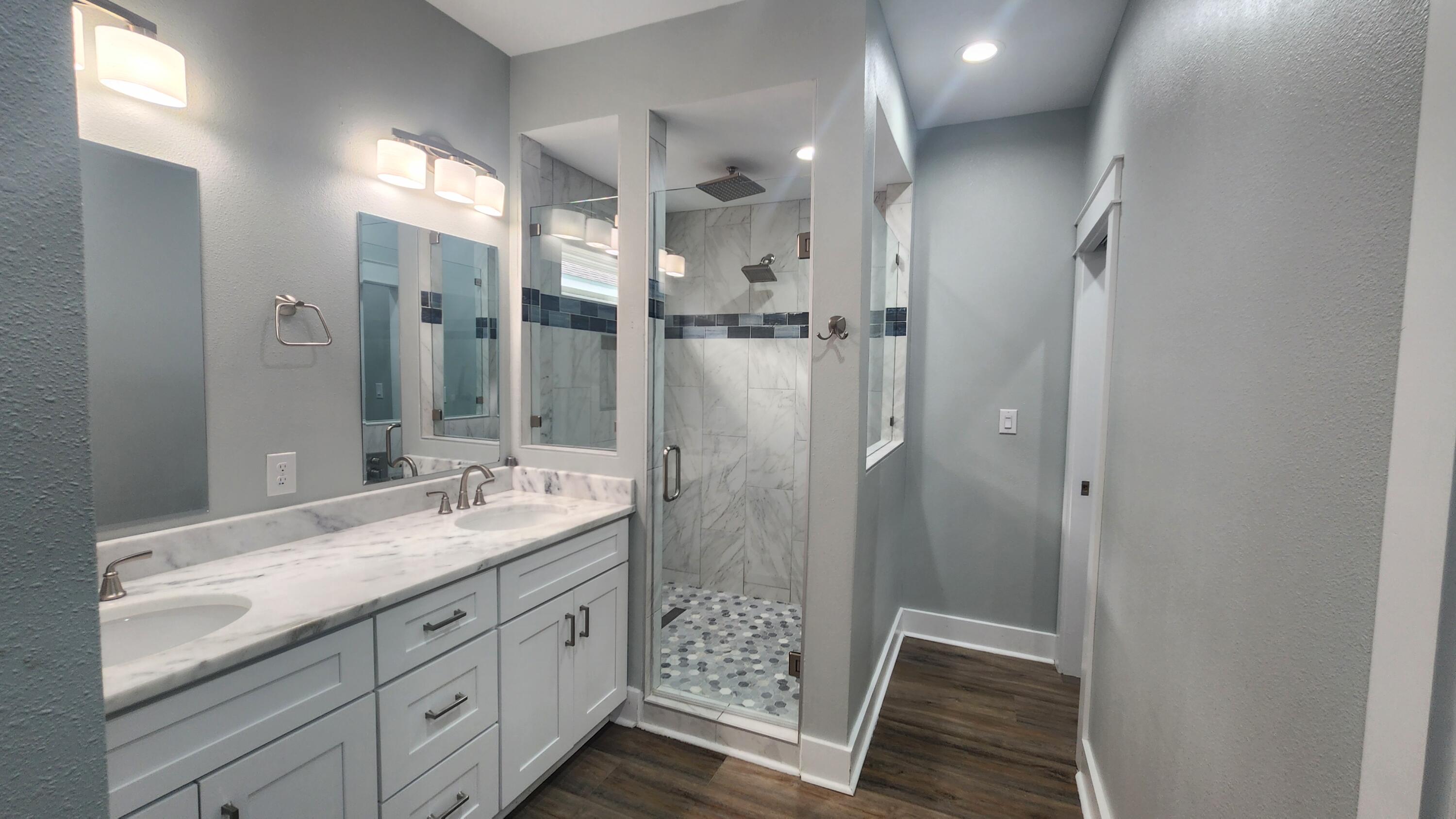 9149 Timber Lane Navarre, FL 32566 - Photo 11 of 44 a bathroom with a shower sink and mirror