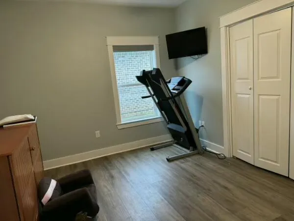 a view of a livingroom with wooden floor and tv