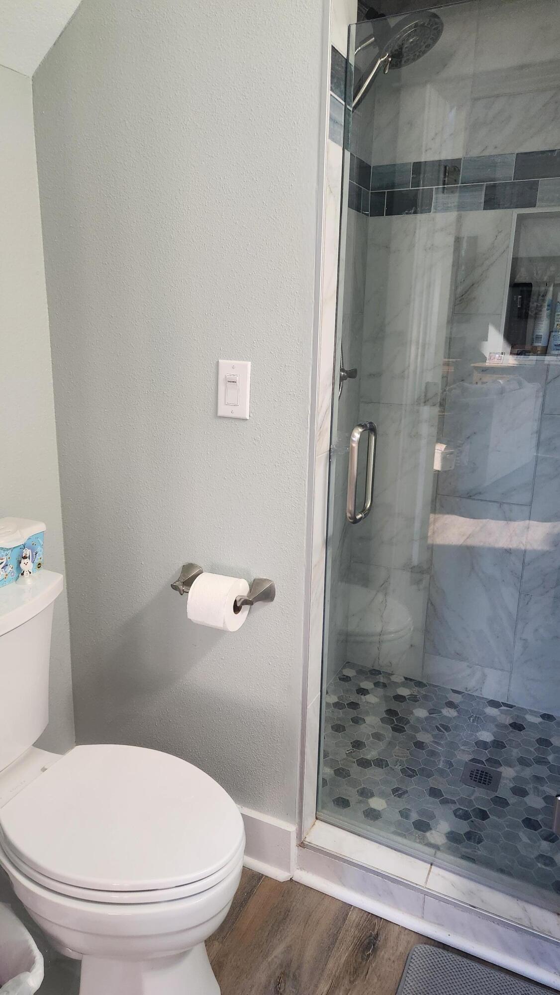 9149 Timber Lane Navarre, FL 32566 - Photo 16 of 44 a white toilet sitting next to a shower