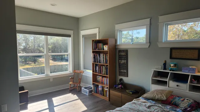 a living room with furniture and a book shelf