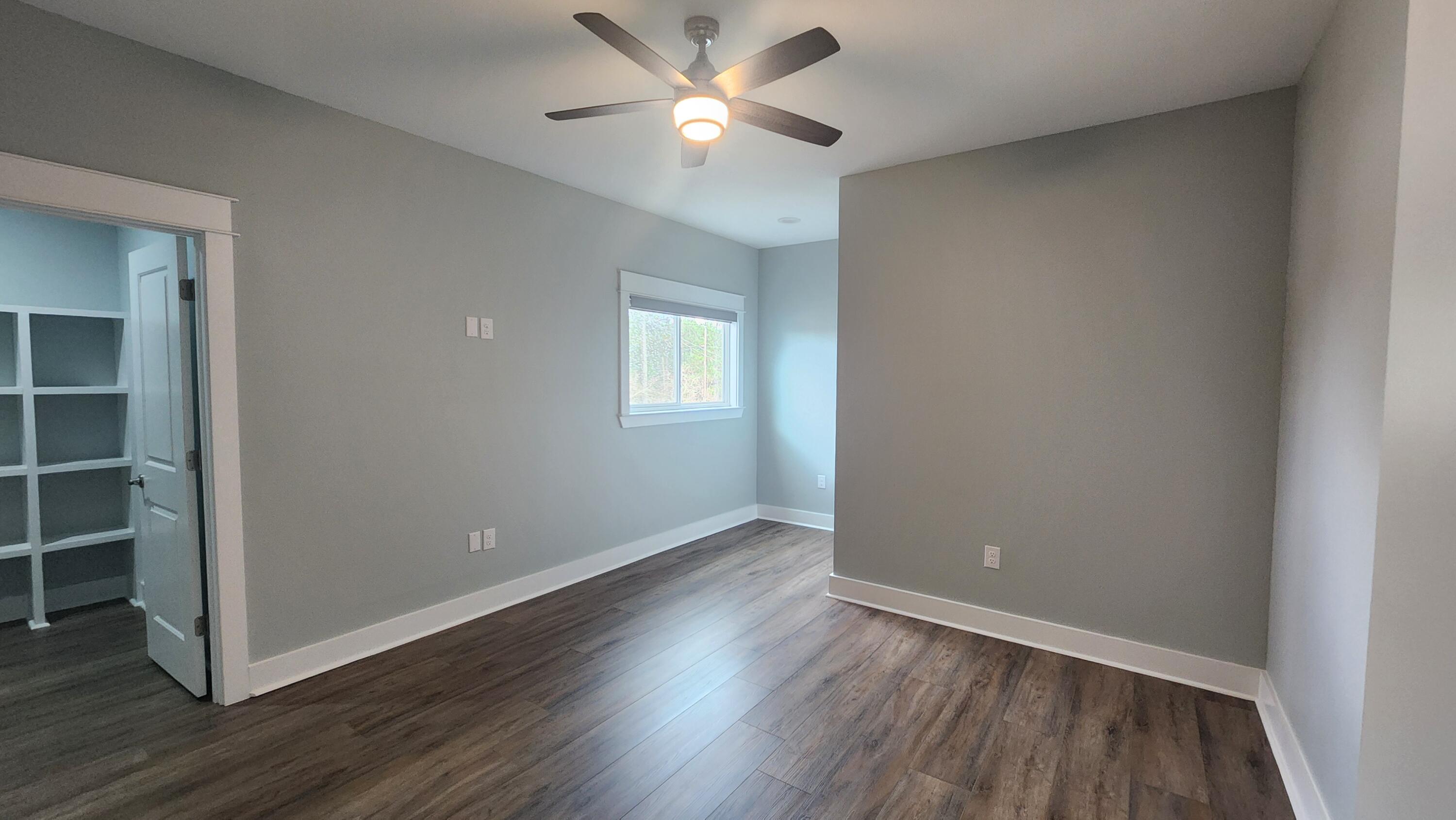 9149 Timber Lane Navarre, FL 32566 - Photo 26 of 44 wooden floor in an empty room with a window