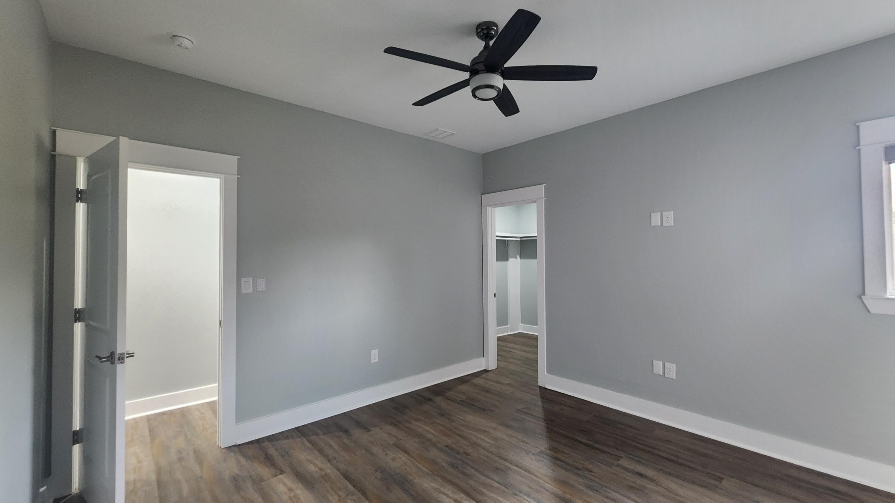 9149 Timber Lane Navarre, FL 32566 - Photo 27 of 44 a view of empty room with wooden floor and fan