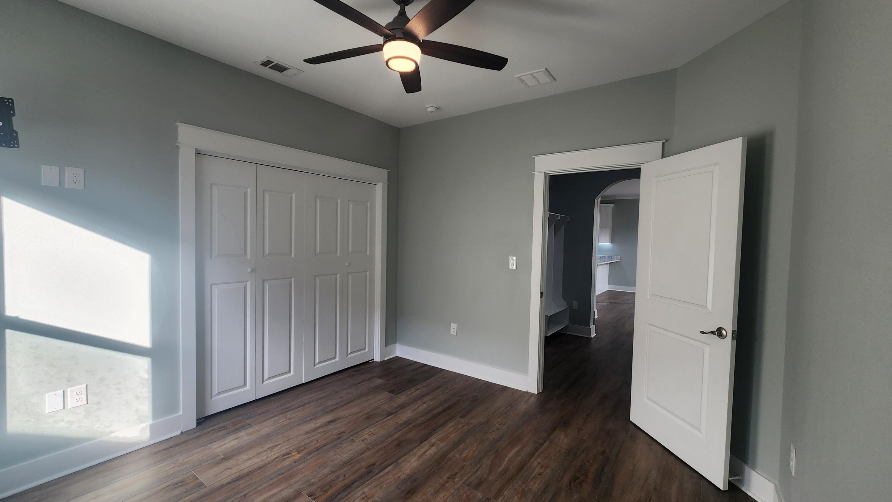 9149 Timber Lane Navarre, FL 32566 - Photo 38 of 44 wooden floor in an empty room with a window