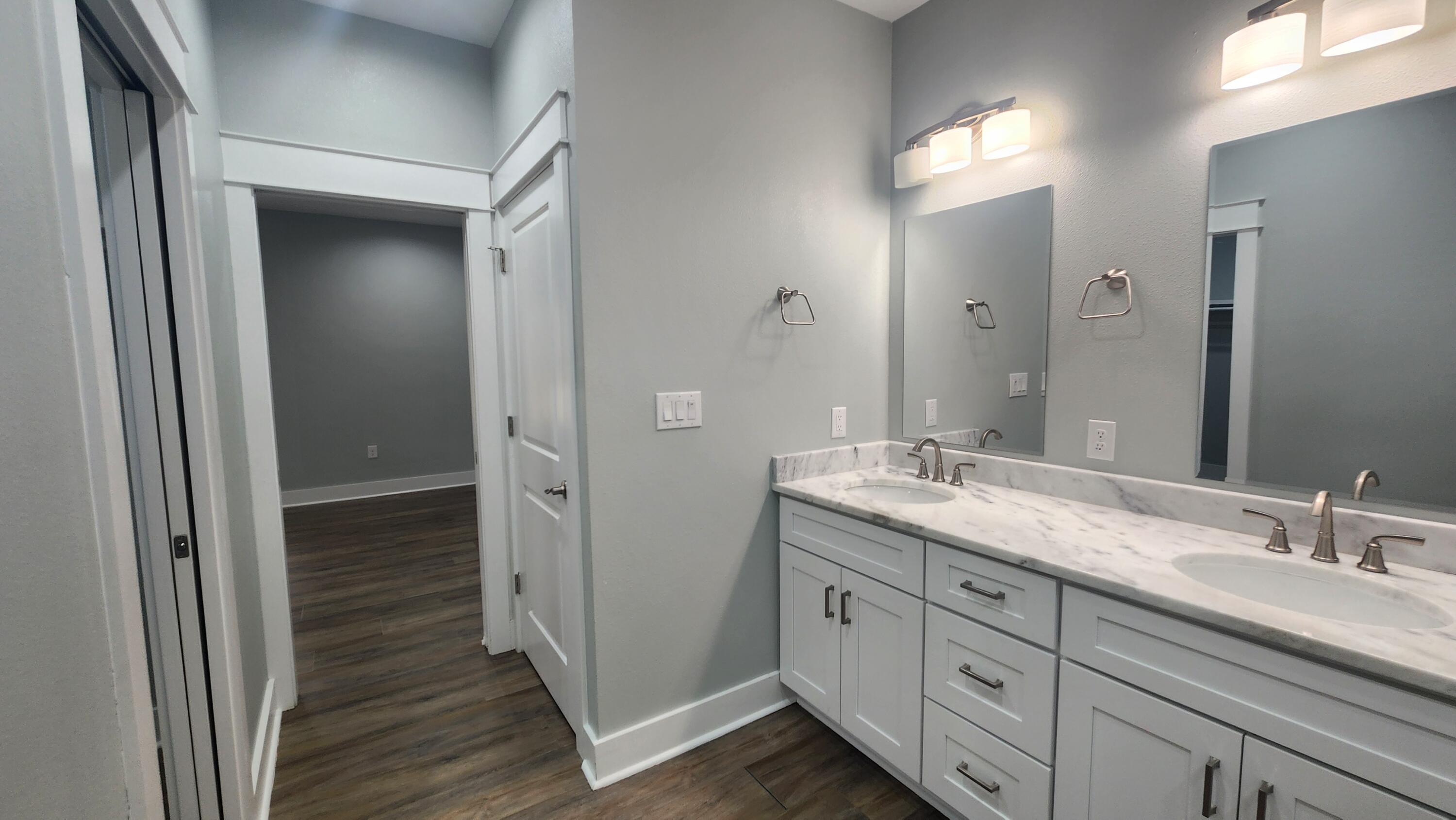 9149 Timber Lane Navarre, FL 32566 - Photo 10 of 44 a bathroom with a granite countertop sink double and mirror