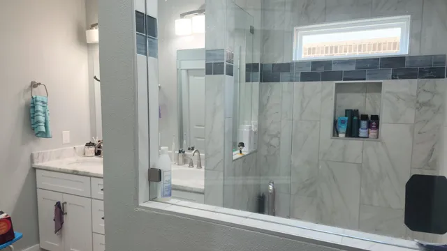 a bathroom with a toilet and mirror