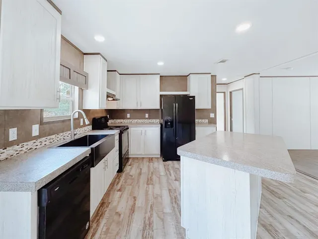 a kitchen with refrigerator and cabinets