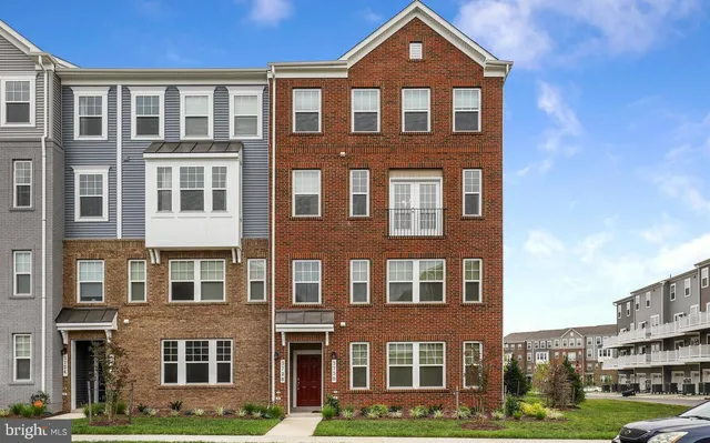 a front view of a residential apartment building with a yard