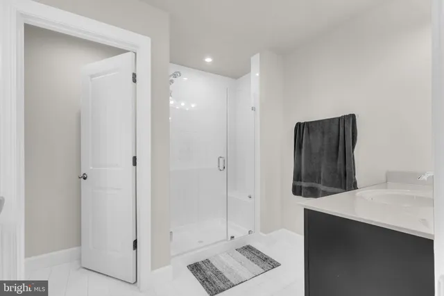 a bathroom with a double vanity sink a mirror and shower
