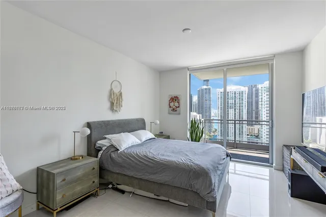 a bedroom with a large bed and a large window