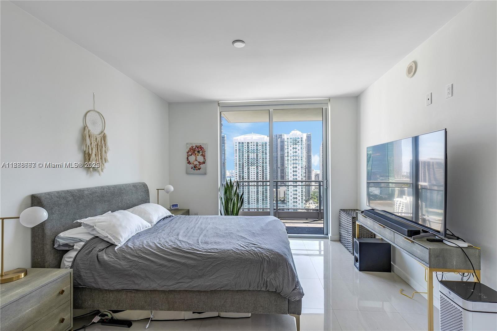 92 Southwest 3rd Street, Unit 3012 Miami, FL 33130 - Photo 13 of 18 a bedroom with a bed and large windows