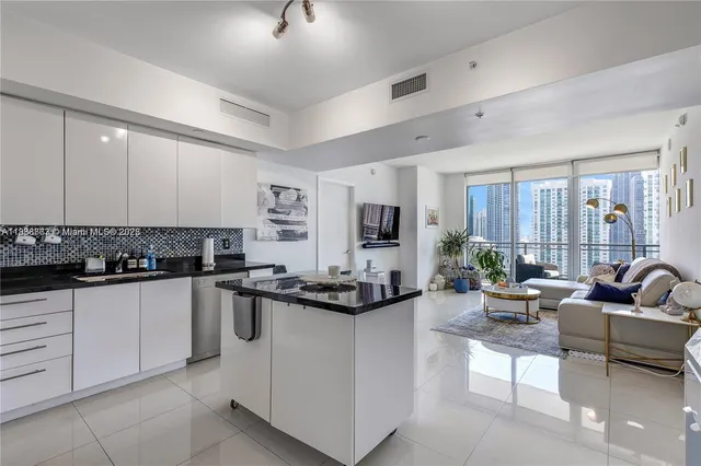 a kitchen with sink stove and cabinets