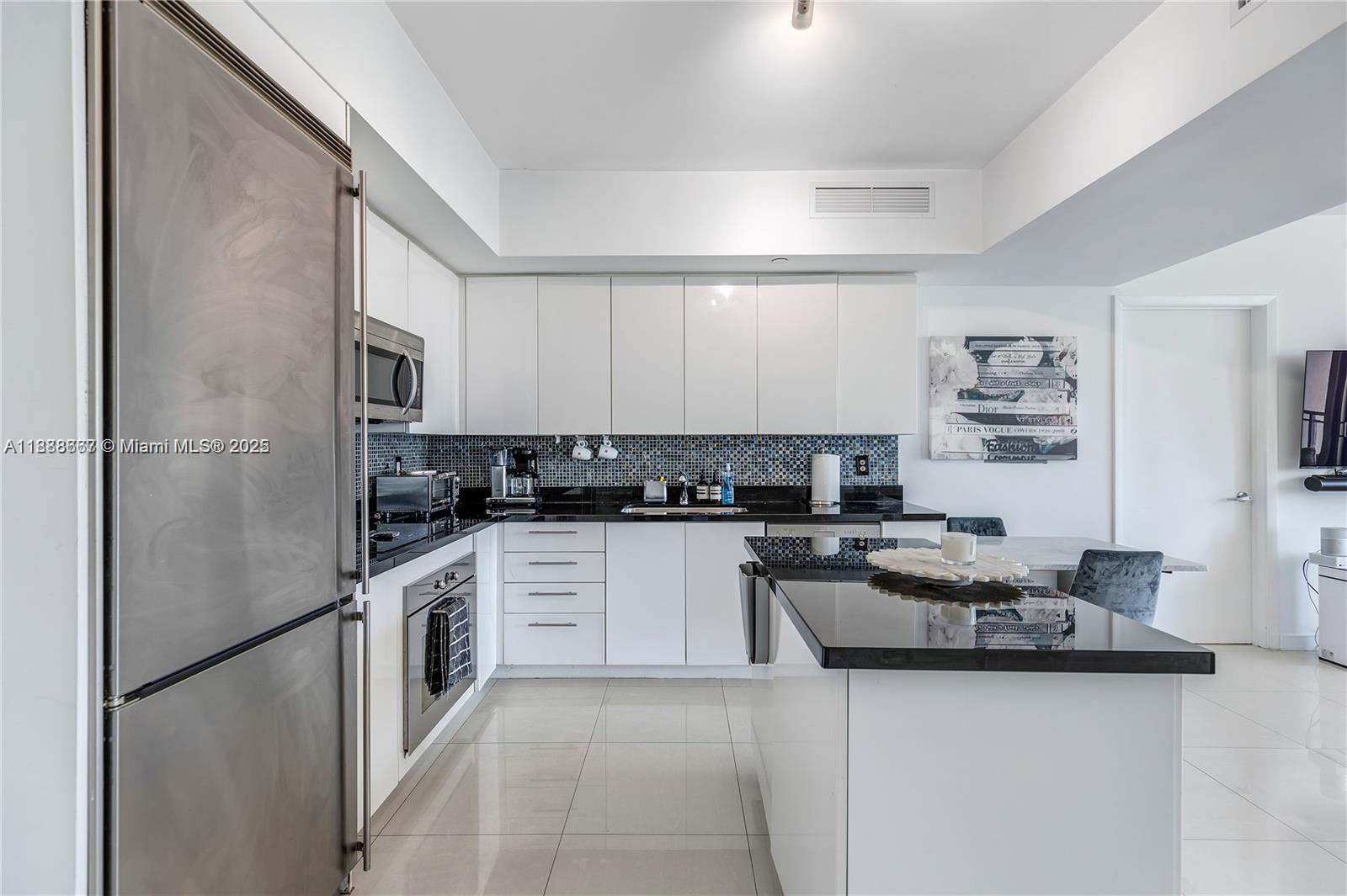 92 Southwest 3rd Street, Unit 3012 Miami, FL 33130 - Photo 6 of 18 a kitchen with stainless steel appliances granite countertop a sink stove and refrigerator