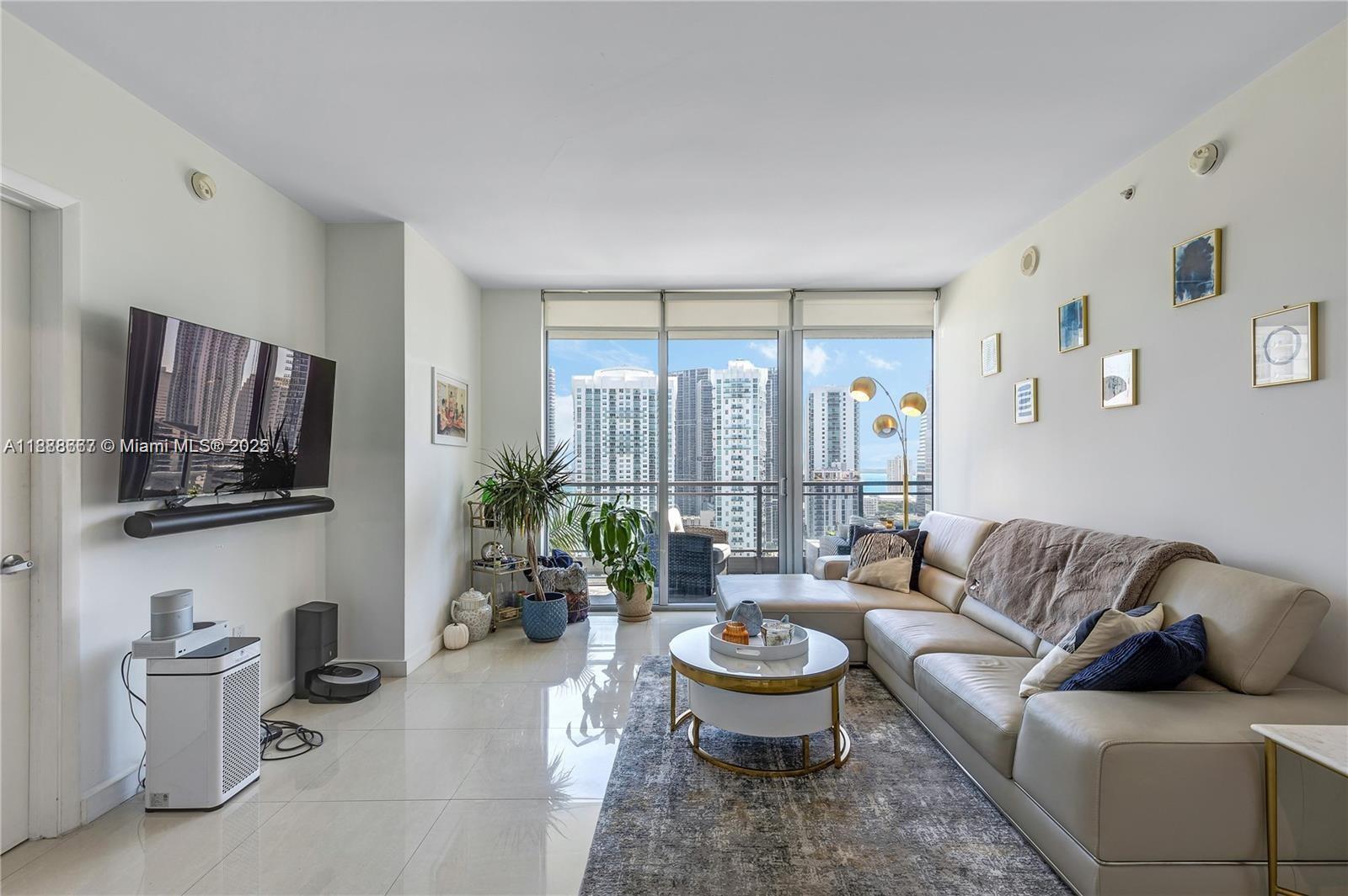 92 Southwest 3rd Street, Unit 3012 Miami, FL 33130 - Photo 7 of 18 a living room with furniture and a flat screen tv