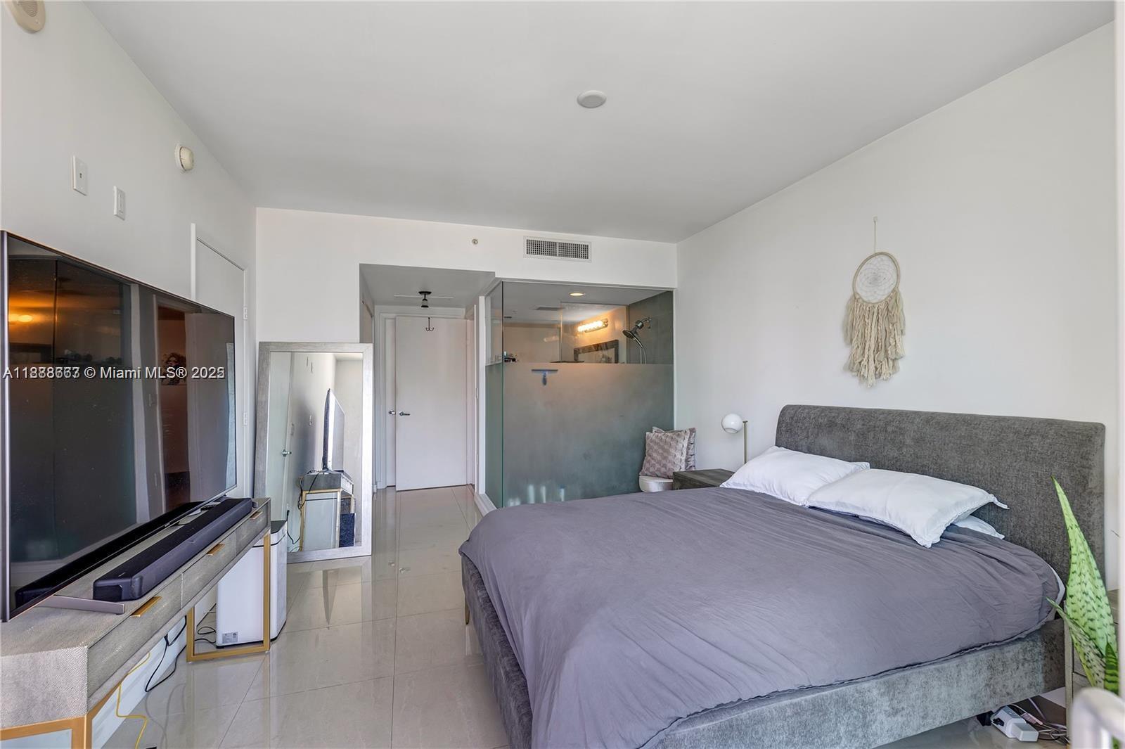 92 Southwest 3rd Street, Unit 3012 Miami, FL 33130 - Photo 10 of 18 a bedroom with a bed and a flat screen tv
