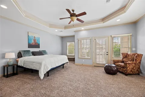 a spacious bedroom with a bed and a large window