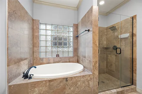 a bathroom with a bathtub and shower