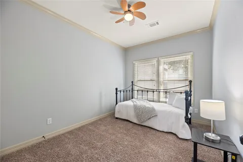 a bedroom with a bed and a lamp