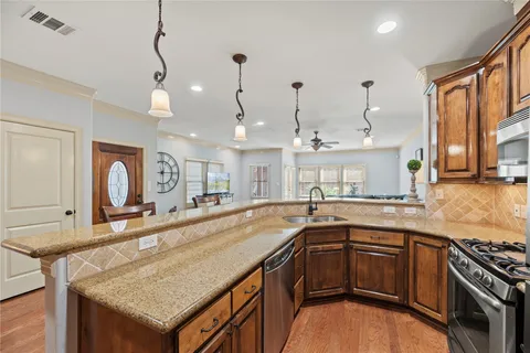 a kitchen with stainless steel appliances granite countertop a stove and a sink