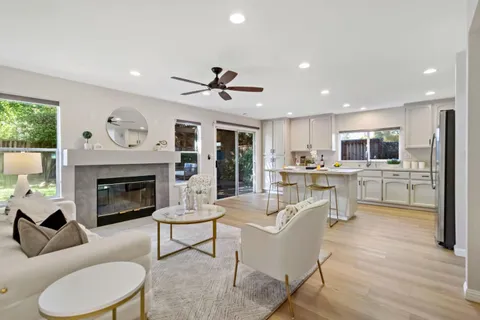 a living room with furniture and a fireplace