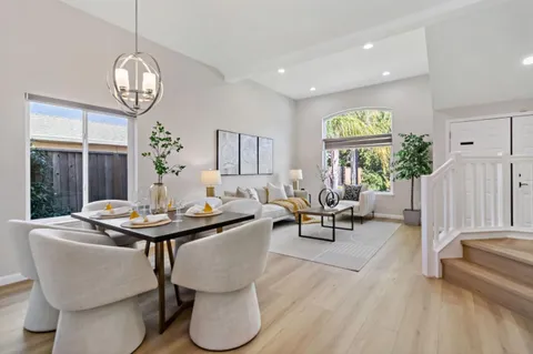 a living room with furniture a window and a chandelier