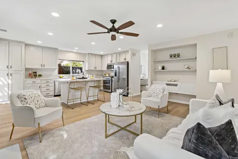 a living room with furniture a window and a chandelier